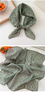 Detailed macro view of green floral cotton linen neckerchief with pink flower patterns