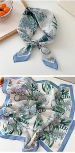 Detailed view of white cotton-linen square scarf with blue border and floral patterns