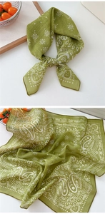 Detail of green cotton linen scarf showing paisley patterns and soft fabric texture