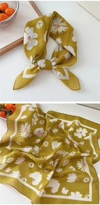 Detail of mustard yellow cotton linen scarf with white daisy print and striped edge