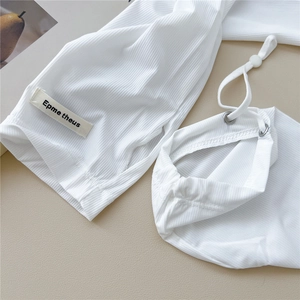 Detail of white ribbed sun protection arm sleeve with drawstring and adjustable toggle