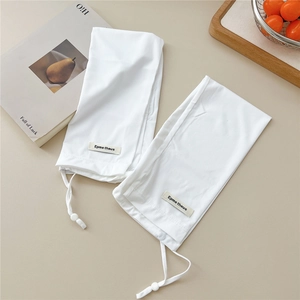 Detailed macro shot of white ribbed sun protection sleeves with adjustable drawstrings