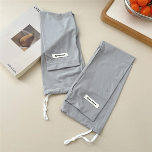 Detail of grey ribbed sun protection sleeves featuring adjustable drawstrings and woven labels