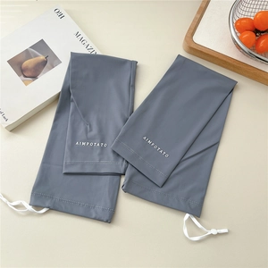 Close-up of grey sun protection cooling sleeves with adjustable drawstring and toggle