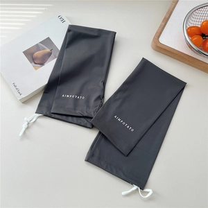 Detail of dark grey sun protection arm sleeves with adjustable drawstring and toggle closure