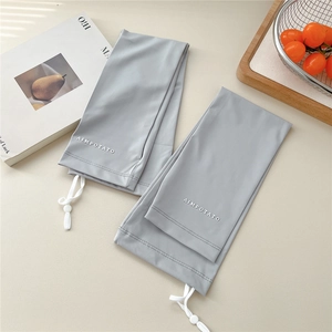 Detail view of light grey sun protection arm sleeves with adjustable drawstring and toggle