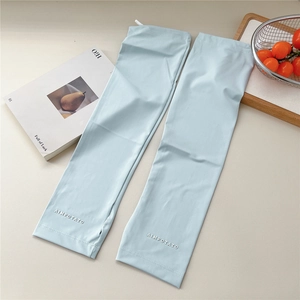 Detail of light blue cooling ice silk sun sleeves with AIMPOTATO logo and elastic cuffs