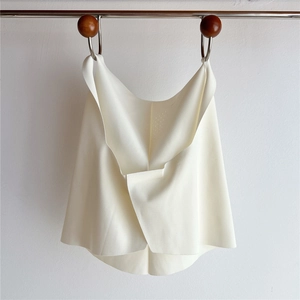 Detail of breathable perforated fabric on back of cream minimalist sun protection vest