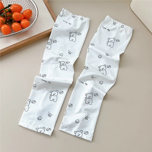Detail of white cooling arm sleeves with a cute cartoon little dog print and text