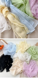 Detail of colorful sheer organza scarves with delicate pearl and rhinestone embellishments