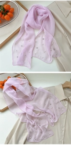 Macro detail of lavender sheer scarf featuring embedded white pearls and silver rhinestones
