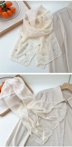 Detail showing the sheer cream scarf with hand-embellished pearls and tiny rhinestones