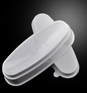 Macro view of two white French nail dipping powder containers with sleek oval design