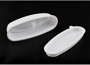 Detail view of a white oval nail dipping tray and French tip manicure tool kit