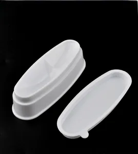 Detailed view of white oval French nail dip powder containers on a black background
