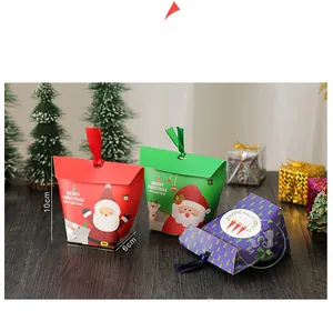 Three-color Christmas gift boxes with Santa patterns and ribbons on wooden background