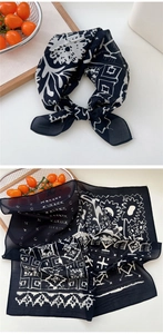 Détails d'un foulard en soie rétro noir et blanc montrant des motifs floraux et géométriques