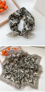 Détail d'un foulard en soie verte avec imprimé équestre et texture lisse élégante