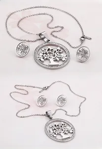 Detailed close-up of silver tree of life jewelry set with sparkling crystals