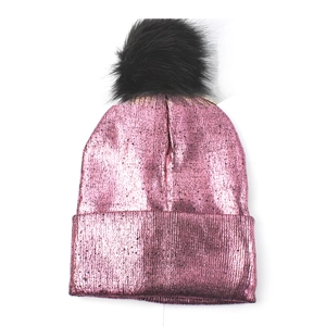 Pink metallic knit beanie with black faux fur pom pom and wide folded cuff detail