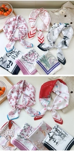 Flat lay detail of printed square silk scarves featuring floral and polka dot patterns