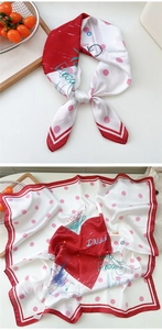 Detail of silk square scarf with red heart patterns and artistic graffiti text elements