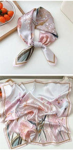 Detailed macro shot of floral silk scarf with elegant pink and gold patterns and texture