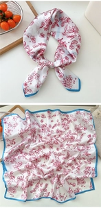 Detailed pattern of floral silk square scarf with blue border and COCO lettering