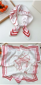 Close-up of strawberry and bow prints on elegant white satin silk square neck scarf