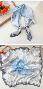 Detail of silk satin square scarf with blue gradient, polka dots and star patterns
