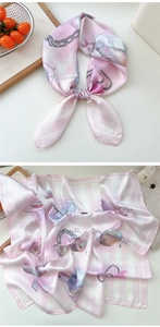 Close-up of pink and white checkered silk scarf with heart and chain patterns
