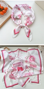 Detailed macro view of a white satin square scarf with red hearts and love pattern print
