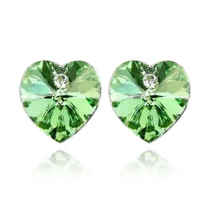Green heart crystal stud earrings with center zircon stone on white background