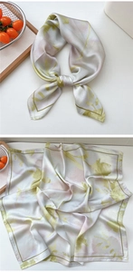 Close-up of a square silk scarf with watercolor floral patterns and satin texture finish