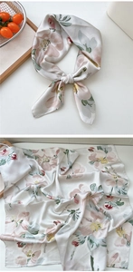 Detailed macro view of floral print silk scarf with West Lafayette lettering and smooth texture