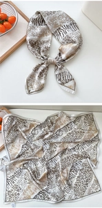 Detailed view of the leopard and zebra print silk scarf with luxury satin texture and colors