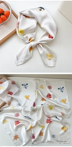 Detailed close-up of a white floral silk scarf featuring bright West Lafayette botanical prints