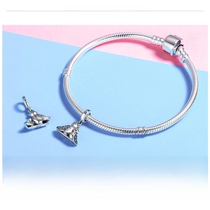 Detail of S925 sterling silver bird charm with blue crystals on a snake chain bracelet
