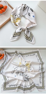 Detail view of square silk scarf with beige artistic print and black striped border