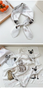 Detail of silk square scarf featuring realistic cat patterns and artistic calligraphy