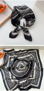 Macro detail of geometric pattern and silk texture on a black and white square scarf