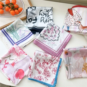 Elegant assortment of printed silk square scarves with floral and geometric patterns