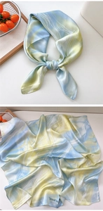 Detail of silk scarf showing marble ink pattern in blue and yellow with West la print