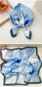 Detail of blue West Lafayette floral silk scarf tied elegantly and laid flat on a table