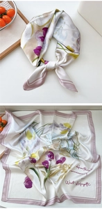 Detail of elegant floral silk scarf in white and lavender with handwritten font design