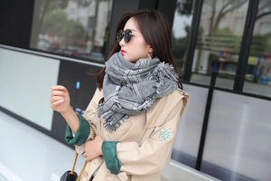 Detail shot of classic gray and white oversized houndstooth scarf with soft fringe tassels