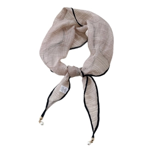 Champagne diamond silk scarf with black trim and pearl charms on white background