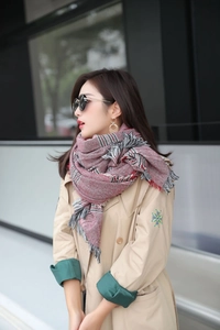 Detail of burgundy oversized check scarf featuring soft fringe trim for winter warmth