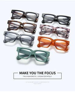 Detailed view of thick square frames with gold cross emblems in multiple vintage colors