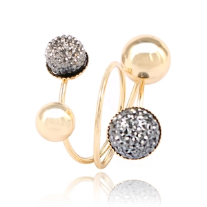 Detail of gold double spiral ring with polished beads and pave-set dark crystals